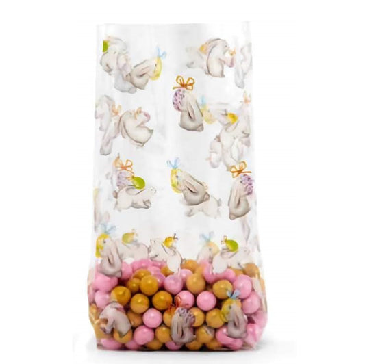 Bunny and Egg Easter themed cello treat bag. The bag is transparent with printed bunnies and eggs. The bag is filled with pink and burnt orange candies