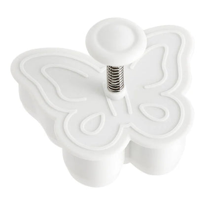 White butterfly-shaped plunger cookie cutter on a white background