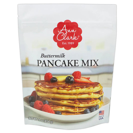 Front of Ann Clark Buttermilk Pancake Mix package featuring a tall stack of golden pancakes topped with syrup, fresh berries, and butter.