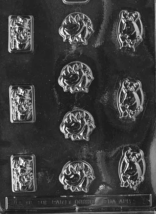 Clear chocolate mold with an assortment of small holiday cavities including a snowman; largest about 1 1/2 by 1 1/2 by 1/2 inch; C008