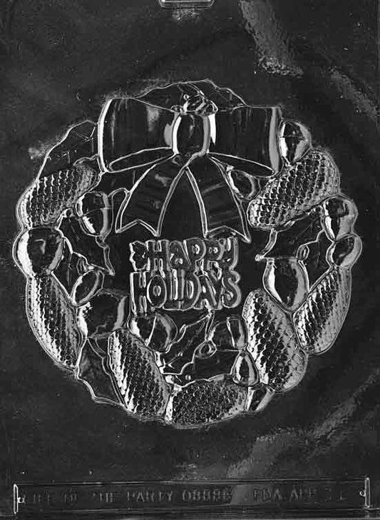 Clear round wreath mold with bow and foliage details; approx. 6 1/4 inches across, shallow 1/4 inch depth; C018