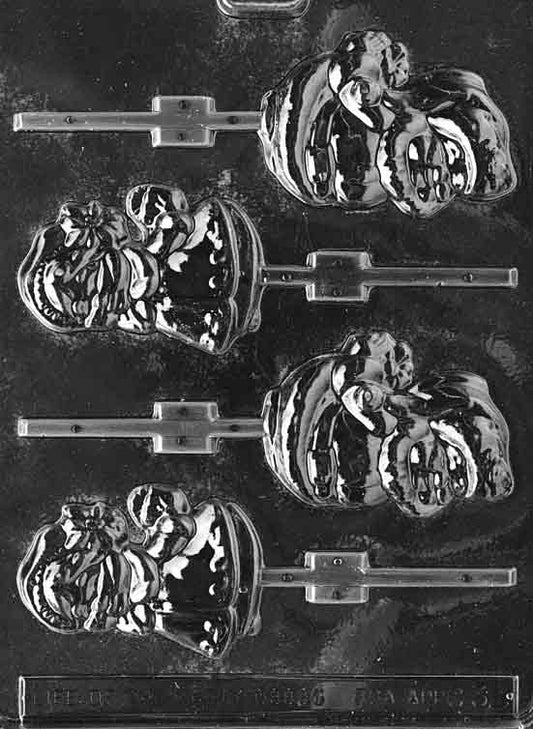 Clear lollipop mold with Santa and Mrs. Claus head profiles; soft facial contours, hat and bonnet detail; mid-depth 7/16 in; C032