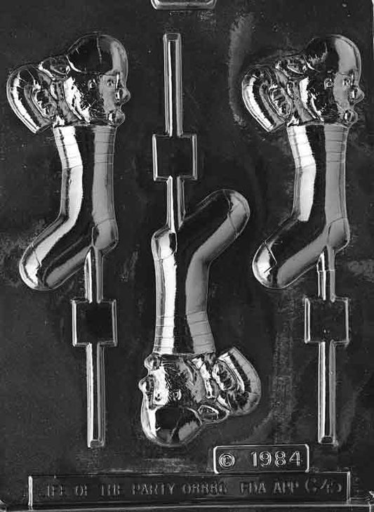 Clear lollipop mold showing a small mouse peeking from a Christmas stocking with cuff; 4.75 × 2.25 × 3/8 in; C045