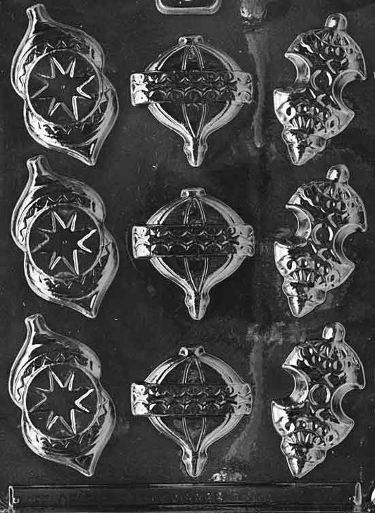 Clear mold with assorted Christmas ornament bulb cavities featuring caps and ridged textures; largest approx. 2 1/4 × 2 3/8 × 1/4 in; C047