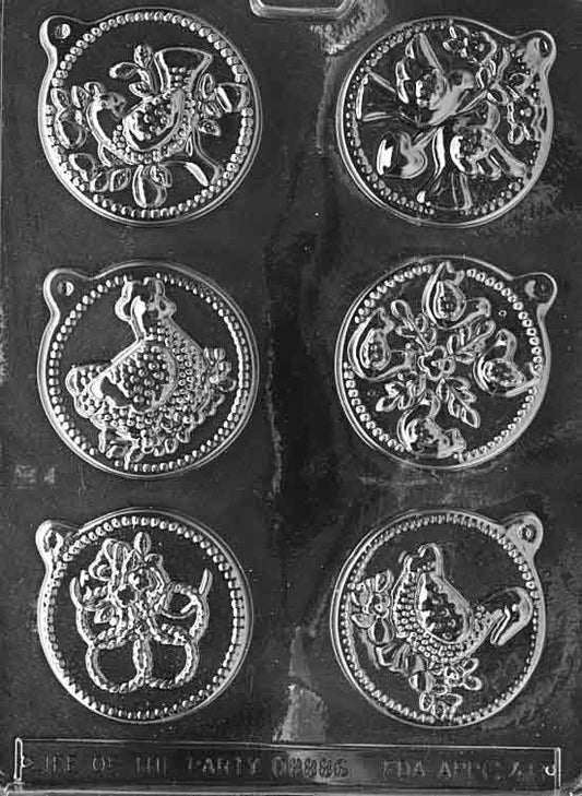 Clear sheet with six round lollipop medallions showing raised “12 Days” imagery; each approx. 2.5 in diameter and 1/2 in deep; C048
