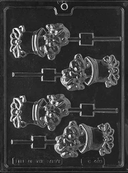 Chocolate mold showing a bear sitting on a large bell shape