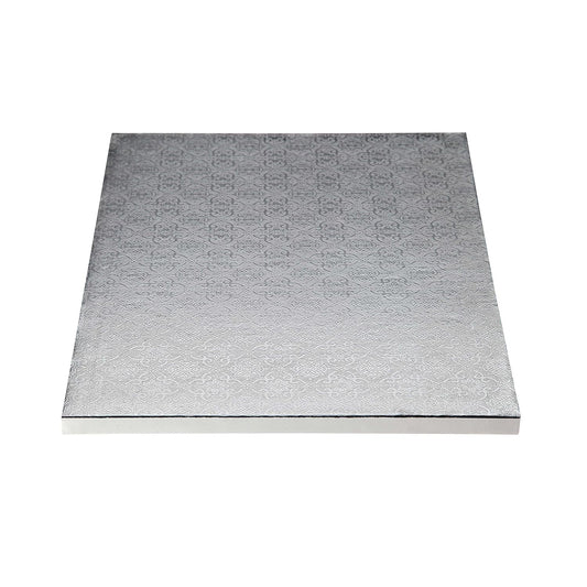 Silver square cake drum board with an embossed decorative pattern and foil-wrapped edges, photographed flat on a white background.