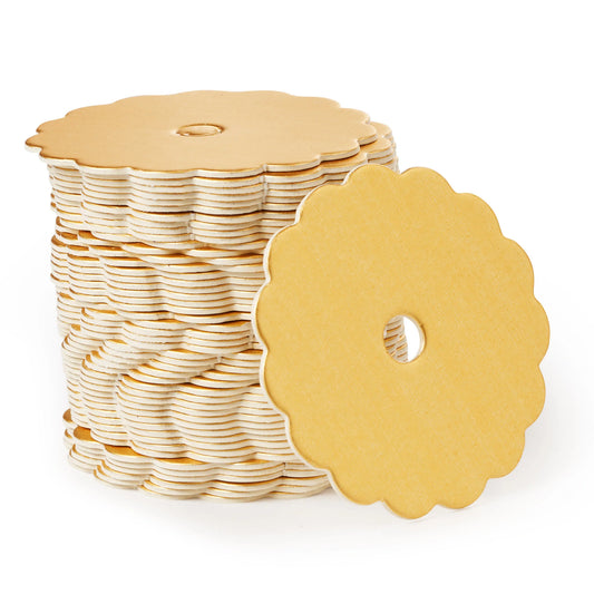 Stack of champagne-colored scalloped cake pop boards with satin finish and center hole for cake pop sticks or decorative straws.