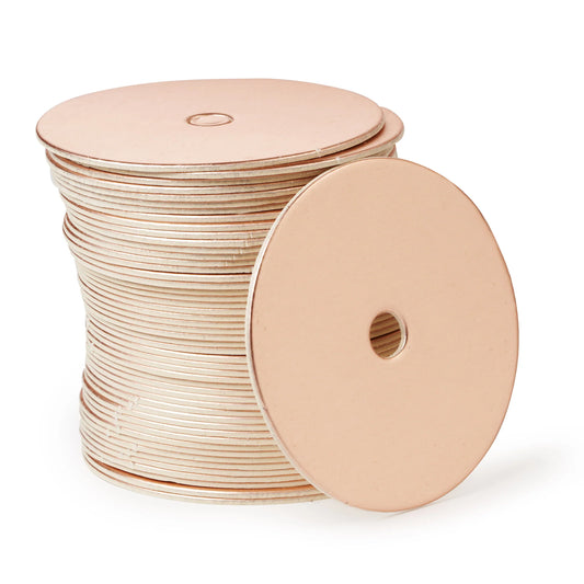 Stack of round rose gold cake pop boards with a satin finish and straight edges, each with a center hole, shown with one board facing forward.