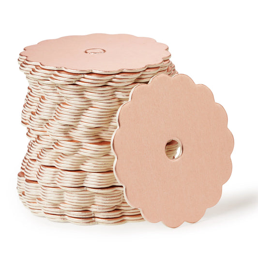 Stack of rose gold scalloped-edge cake pop boards with a center hole, ideal for displaying cake pops in a polished and elegant way.