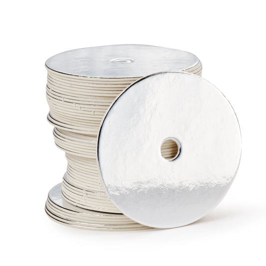 Stack of round silver straight-edged cake pop boards with center hole, used for elegant cake pop displays or platter presentations.
