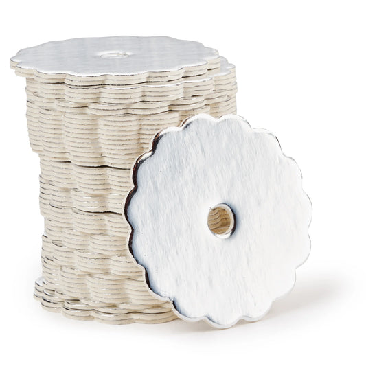 Stack of silver scalloped-edge cake pop boards with a shiny finish, each with a center hole, shown with one board propped forward to display detail.