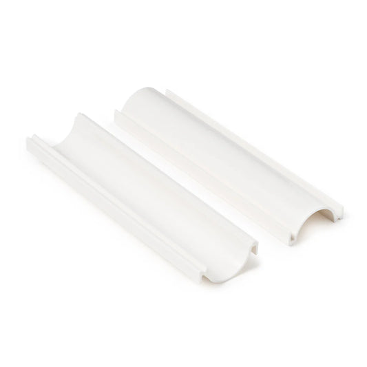 White cake pop roller shown separated into two matching curved channel pieces with raised rails and rounded ends on a white background.