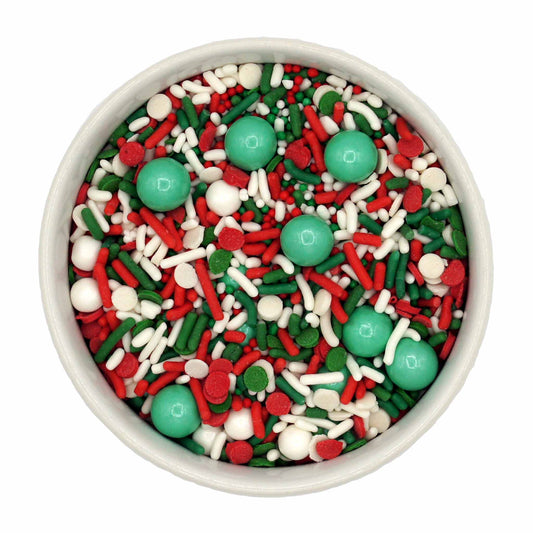 A vibrant mix of red, white, and green sprinkles, including jimmies, Sixlets, sugar pearls, and round quins, perfect for decorating holiday-themed desserts.