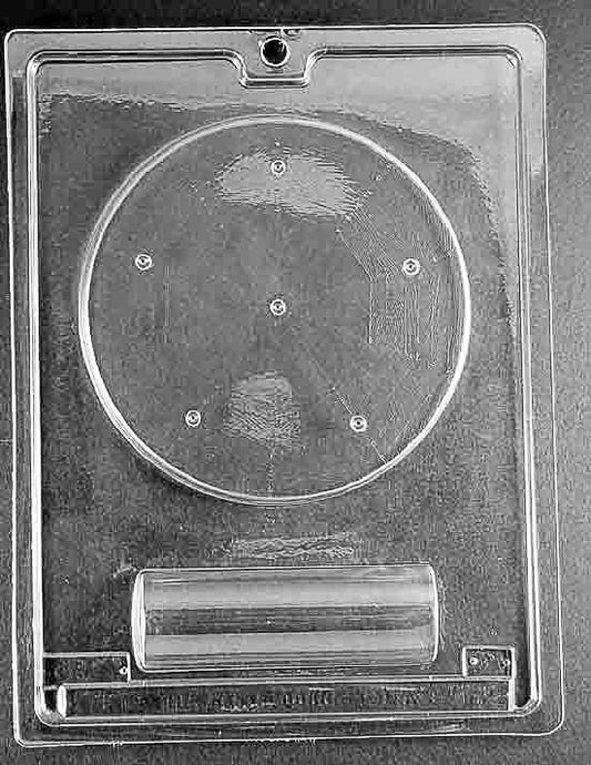 Clear plastic mold with a circular base cavity and a separate cylindrical pillar cavity designed to support a chocolate carousel.