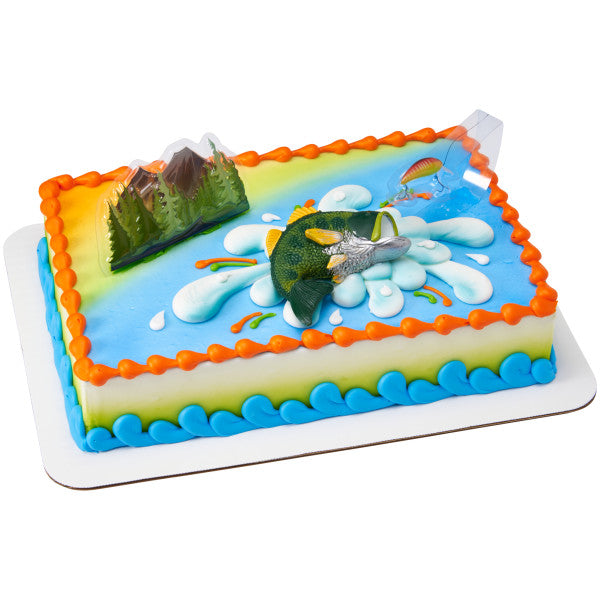 A rectangular cake decorated with water and outdoor-themed icing, featuring the fish, forest, and bait toppers.