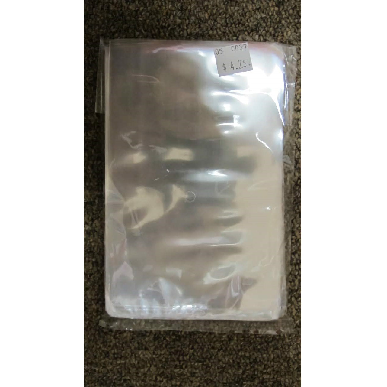 This image shows a package of 100 clear cello bags, sized 4 x 6 inches, on a brown carpeted surface. The packaging gives a glimpse of the stacked cello bags inside, ideal for packaging treats and candies.