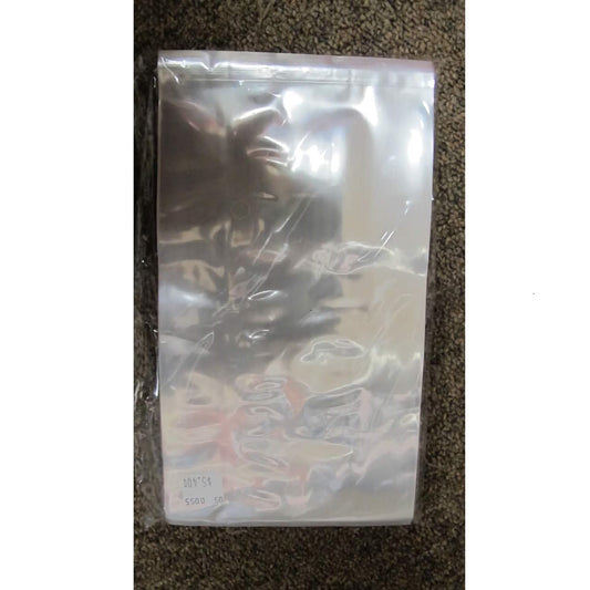 A sealed package containing 100 clear cellophane bags with dimensions of 5 x 8 inches, placed on a textured brown carpet. The package has a glossy surface with light reflections.