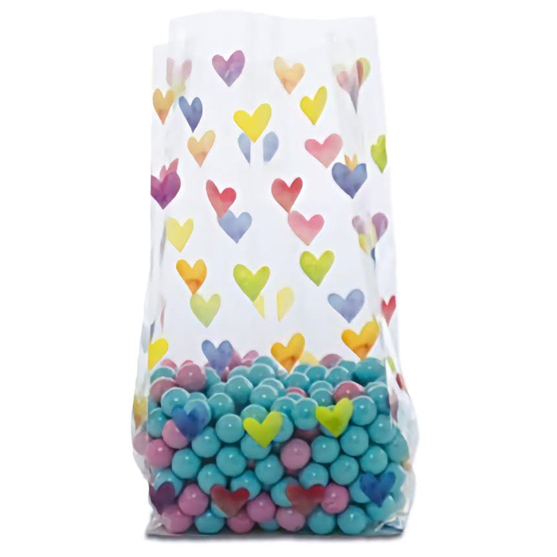 A cellophane treat bag adorned with a colorful array of watercolor-style hearts in shades of blue, yellow, pink, and purple, partially filled with candy to showcase the playful design.