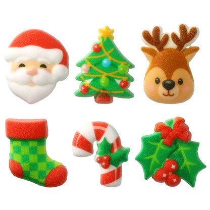 Assorted holiday pressed sugar decorations on a white background, including a Santa face with red hat, green Christmas tree with ornaments, reindeer head with antlers, green stocking, striped candy cane, and holly leaves with red berries.
