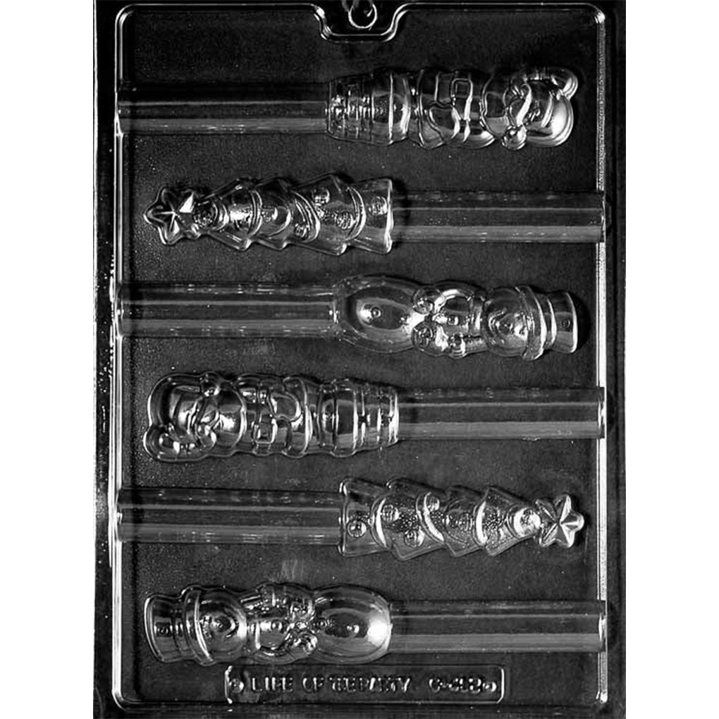 Clear plastic chocolate mold for pretzel rod toppers with six holiday-shaped cavities, including Santa, Christmas tree, and snowman designs, each with a long pretzel rod channel on a dark background.