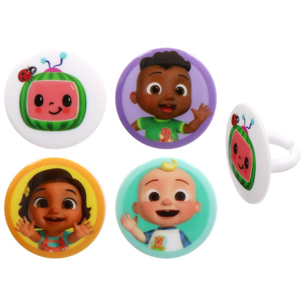 Assorted Moonbug character cake rings with round toppers, including a smiling watermelon TV icon with a ladybug and three kid characters in purple, yellow, and teal circles on a white background.