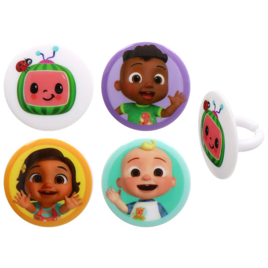 Assorted Moonbug character cake rings with round toppers, including a smiling watermelon TV icon with a ladybug and three kid characters in purple, yellow, and teal circles on a white background.