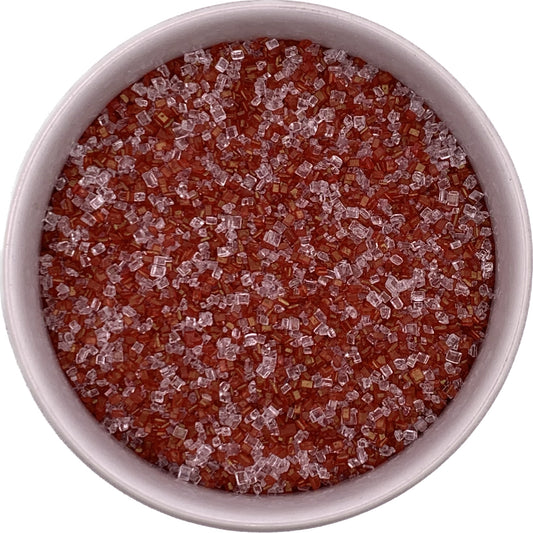 Close-up of red and sparkling white coarse sugar mix in a bowl, perfect for decorating baked goods.