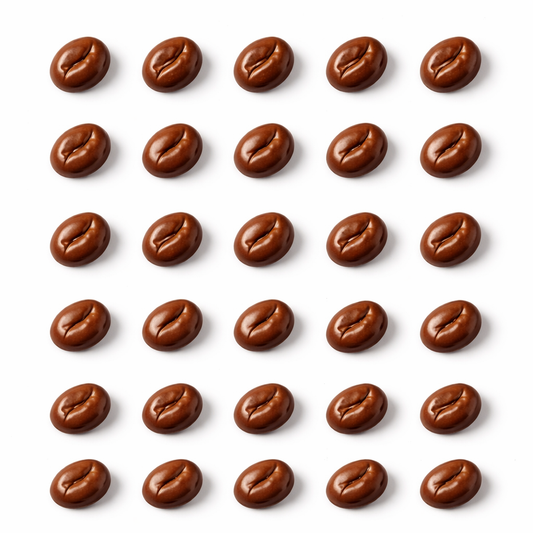 Grid of glossy coffee bean–shaped chocolates arranged in neat rows on a white background, each piece featuring a curved center groove and smooth, rounded edges.
