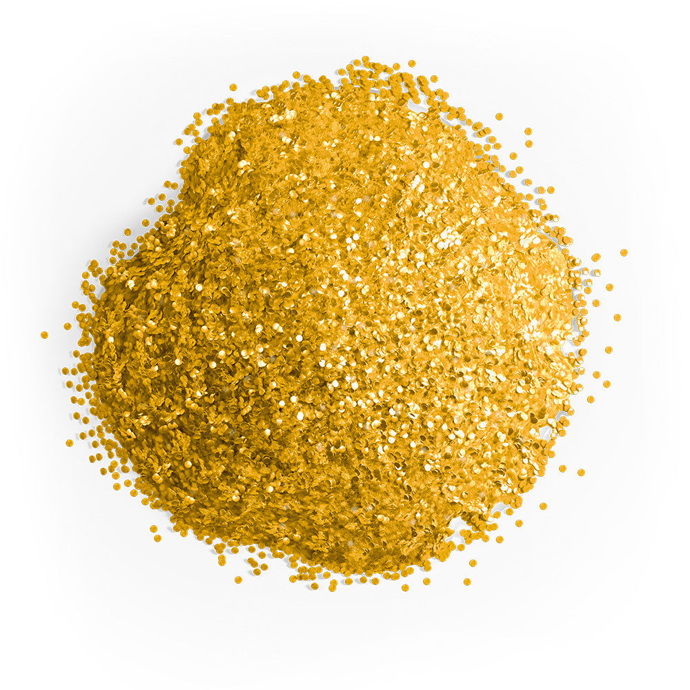 Close-up mound of Colour Mill gold edible glitter showing densely packed reflective golden particles scattered across a white background.