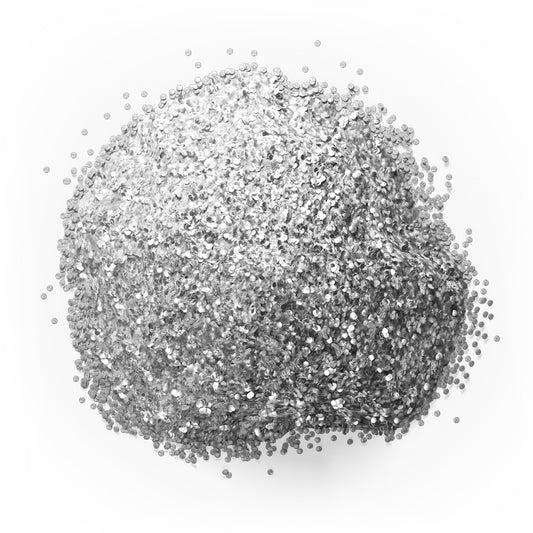 Close-up mound of Colour Mill silver edible glitter showing densely packed reflective silver particles with bright and charcoal-grey highlights on white.