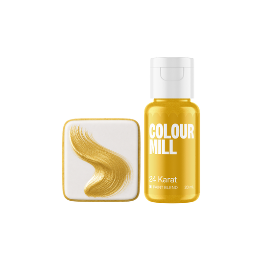Colour Mill 24 Karat Metallic Paint Blend bottle beside a white square cookie decorated with a sweeping curved brushstroke of radiant gold edible paint.