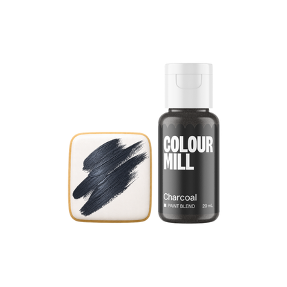 Colour Mill Charcoal Metallic Paint Blend bottle beside a white square cookie decorated with broad textured brushstrokes of dark charcoal-grey edible paint.