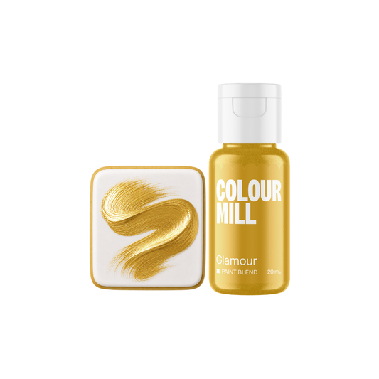 Colour Mill Glamour Metallic Paint Blend bottle beside a white square cookie decorated with a sweeping brushstroke of rich gold metallic edible paint.