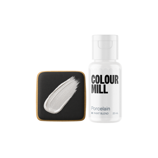 Colour Mill Porcelain Metallic Paint Blend bottle beside a black square cookie decorated with a smooth brushstroke of pearly white metallic edible paint.