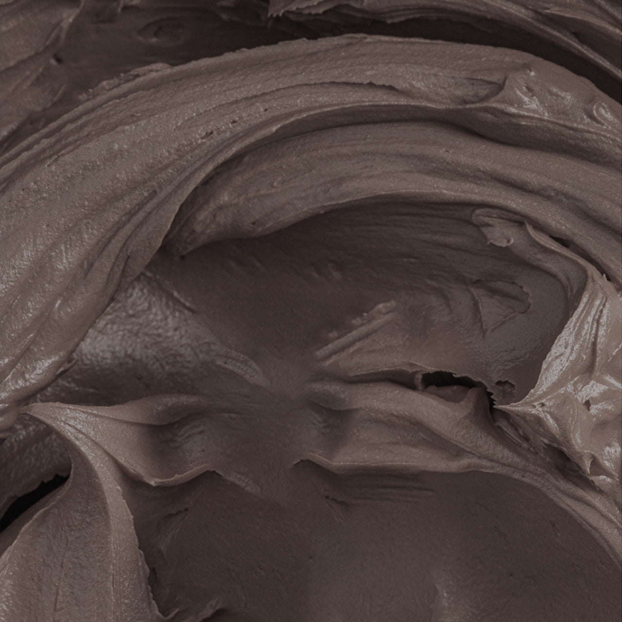 Close-up of chocolate brown buttercream tinted with Colour Mill Coffee Oil Blend, showcasing smooth, creamy texture.