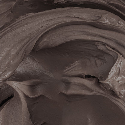 Close-up of chocolate brown buttercream tinted with Colour Mill Coffee Oil Blend, showcasing smooth, creamy texture.