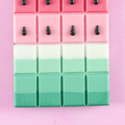 Watermelon-inspired chocolate bar featuring pink, white, and emerald green layers with chocolate “seeds.”