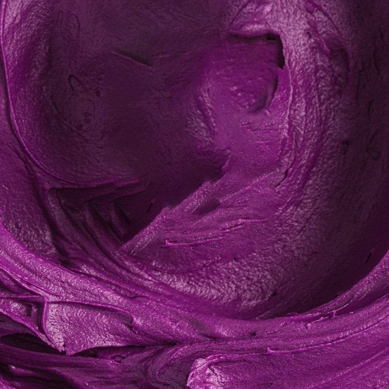 Close-up of smooth, vibrant purple buttercream colored with Colour Mill Grape.