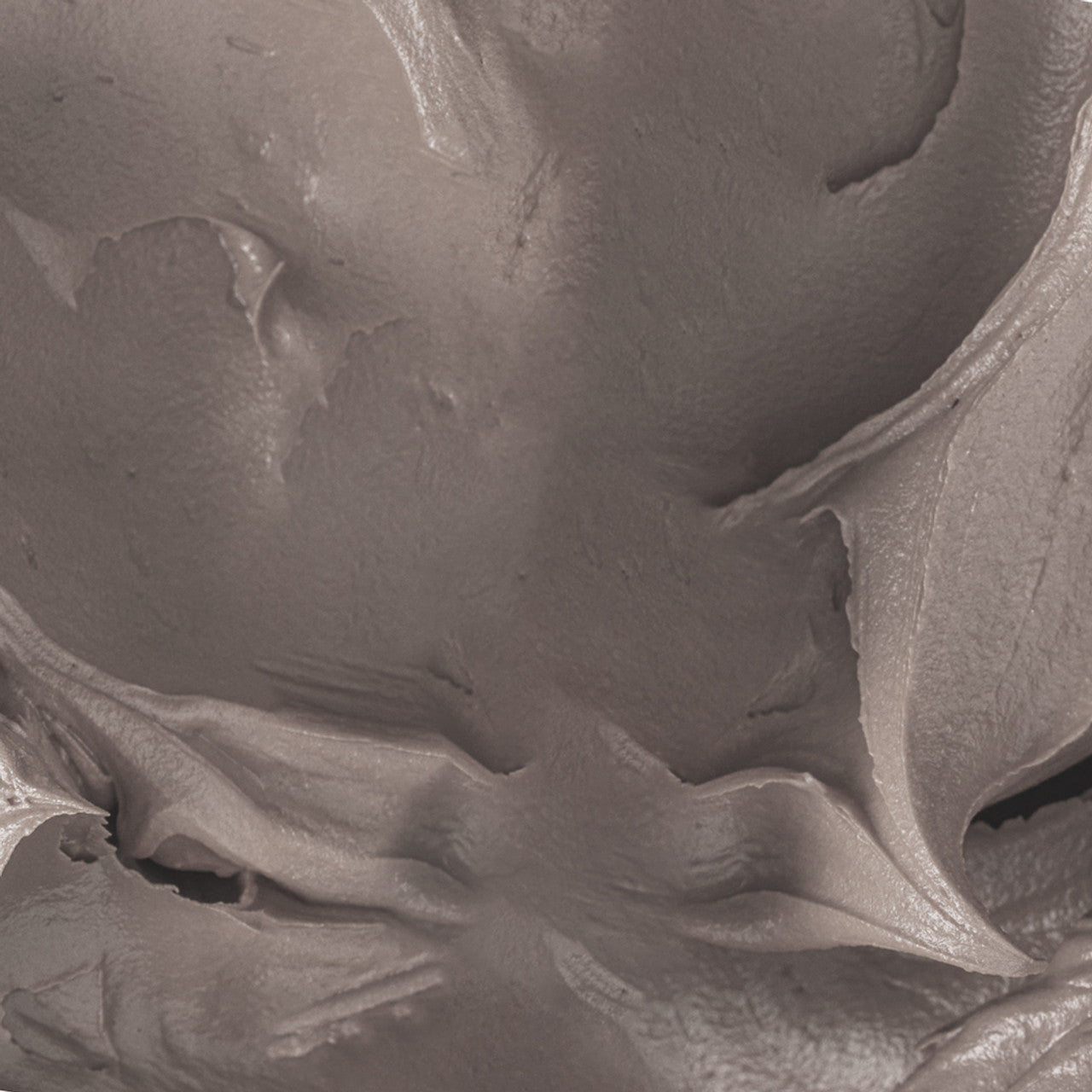 Close-up of buttercream dyed with Colour Mill Pebble oil-based food coloring – smooth, natural greige shade