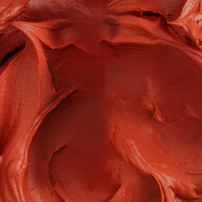 Richly blended buttercream tinted with Colour Mill Sunset oil-based coloring in a deep red-orange tone