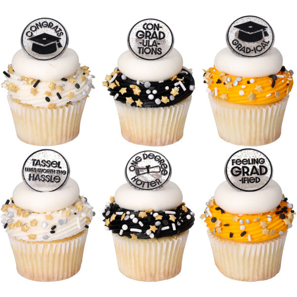 Six cupcakes with white, black, and orange frosting swirls topped with white icing discs, graduation sprinkle mixes, and confetti grad cupcake rings.