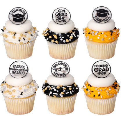 Six cupcakes with white, black, and orange frosting swirls topped with white icing discs, graduation sprinkle mixes, and confetti grad cupcake rings.