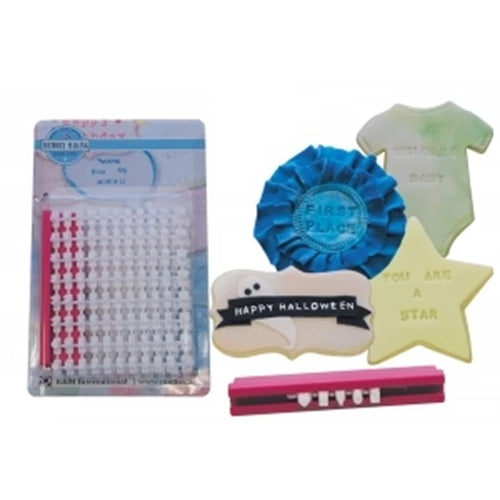 Cookie decorating message stamper kit displayed next to stamped treats, including a blue “FIRST PLACE” ribbon cookie, a star cookie, and a small onesie-shaped cookie.