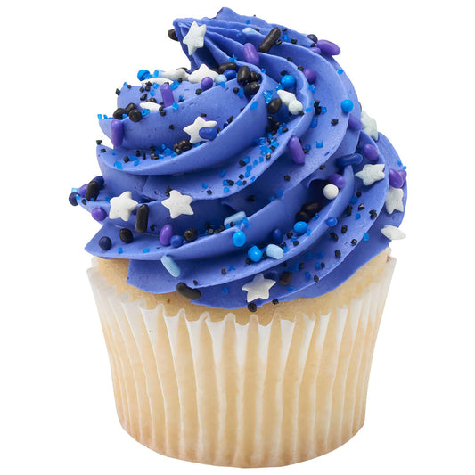 A cupcake with vibrant blue frosting topped with Cosmic Skies sprinkle blend, decorated with star shapes and various colored beads, creating a galaxy-themed dessert experience.