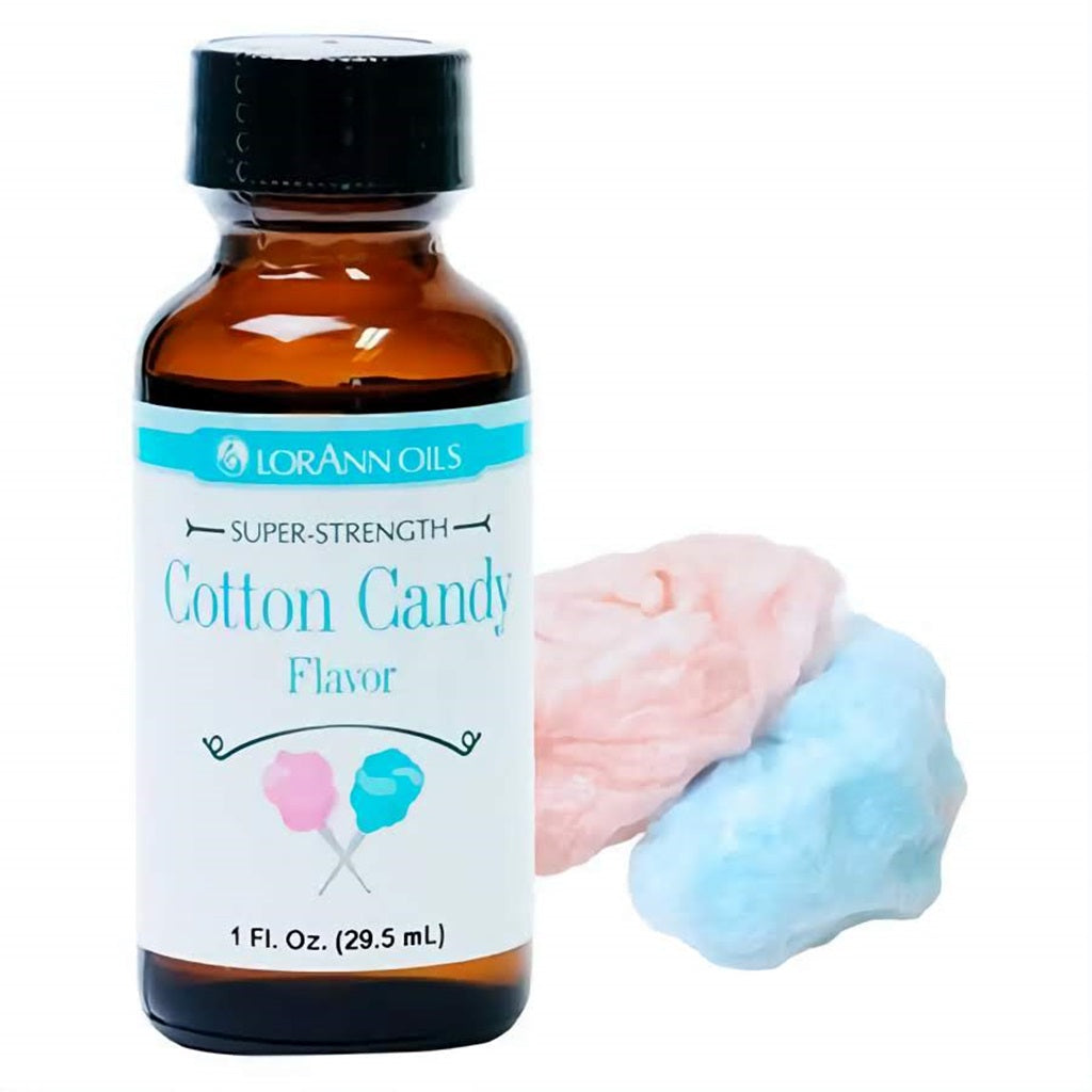 LorAnn Oils Super Strength Cotton Candy Flavor in a 1 fl oz bottle, paired with fluffy pink and blue cotton candy, evoking the sweet, airy treat.