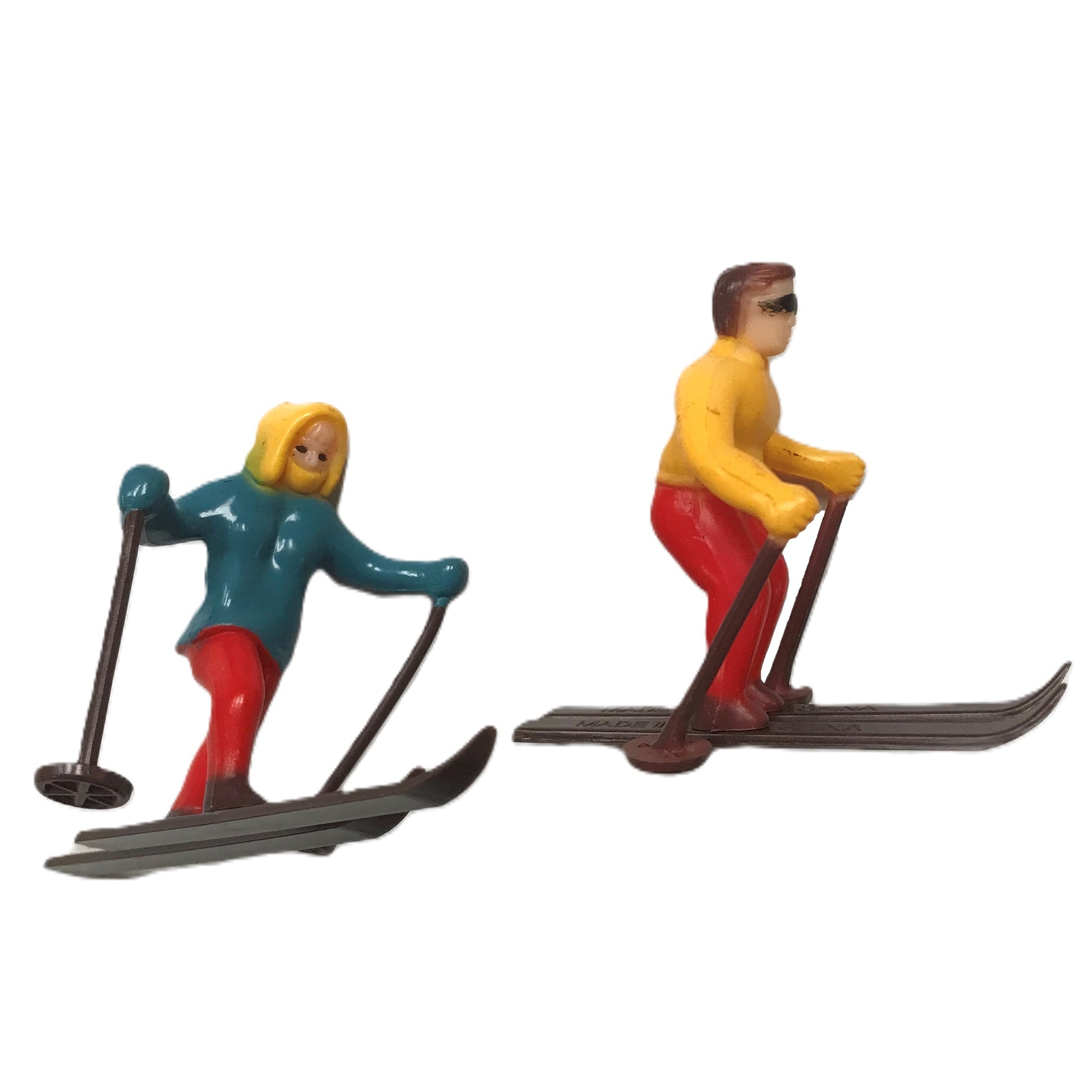 Dynamic cross-country skiing cake topper set, featuring figures in colorful skiing attire, poised in active skiing stances, suitable for winter sports themed cakes.