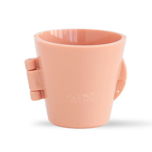 Peach latte cup shaped cake pop mold standing closed against a white background, featuring a glossy cup silhouette with a side hinge and smooth tapered sides.