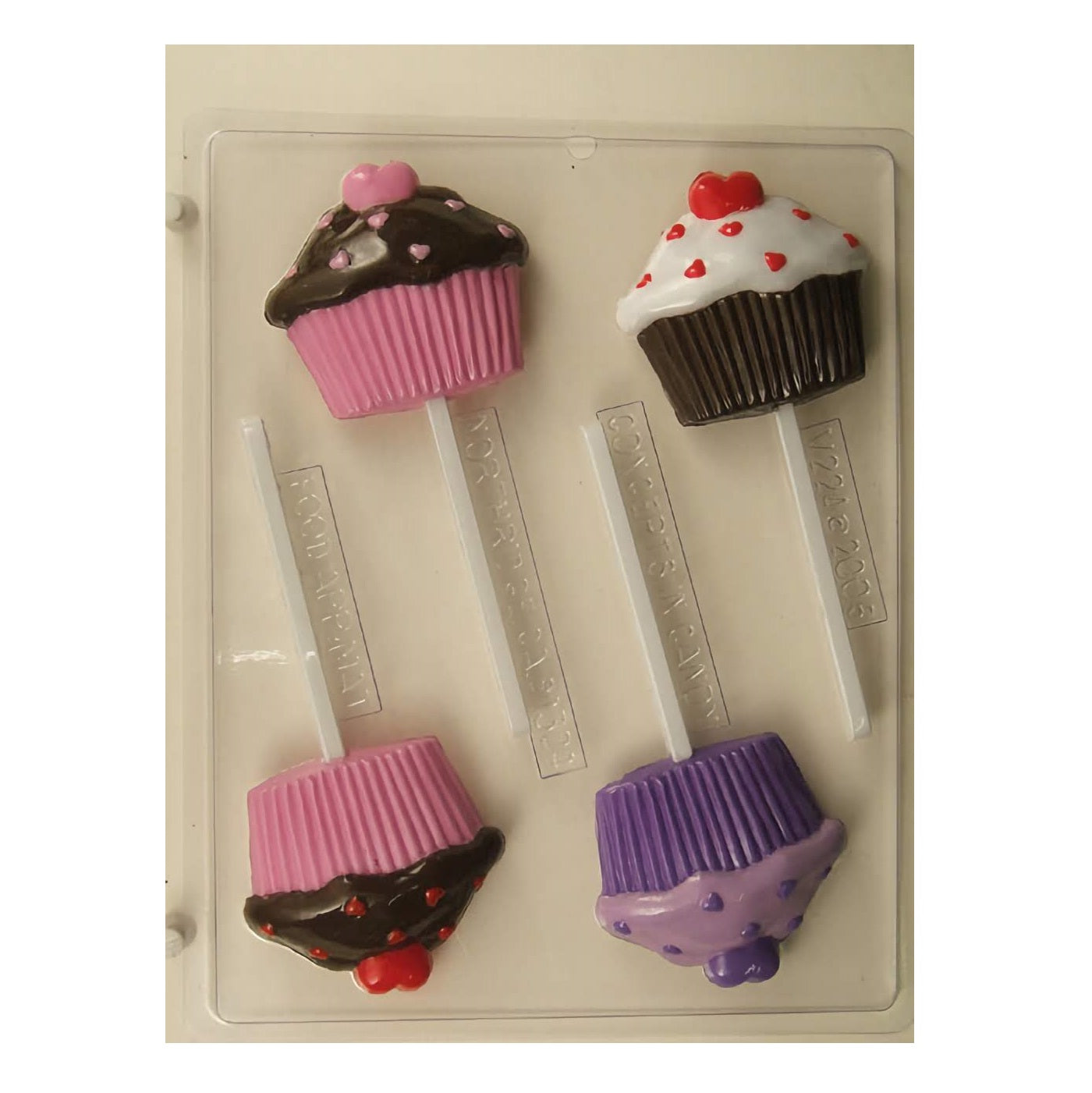Chocolate sucker mold with three cupcake-shaped cavities, each topped with different decorative elements like hearts and sprinkles, alongside examples of finished chocolate cupcakes showcasing vibrant colors and designs.