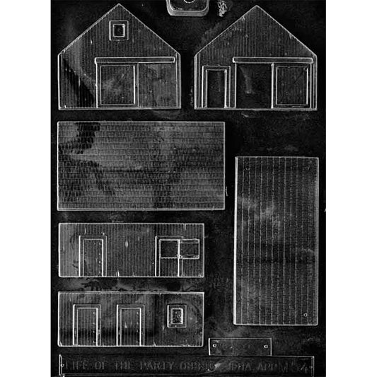 Clear plastic chocolate mold with multiple barn building panel cavities, including roof and wall pieces with plank-style lines and outlined doors and windows.